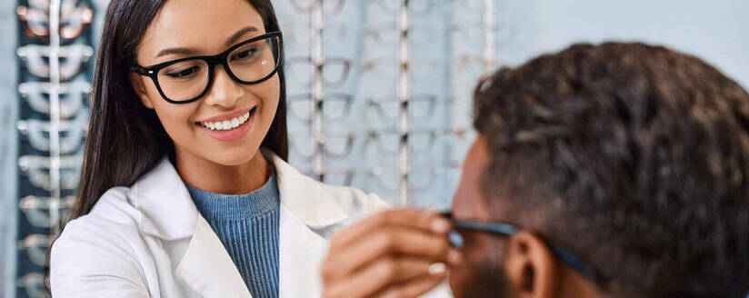 Image of an optician helping a patient find new glasses