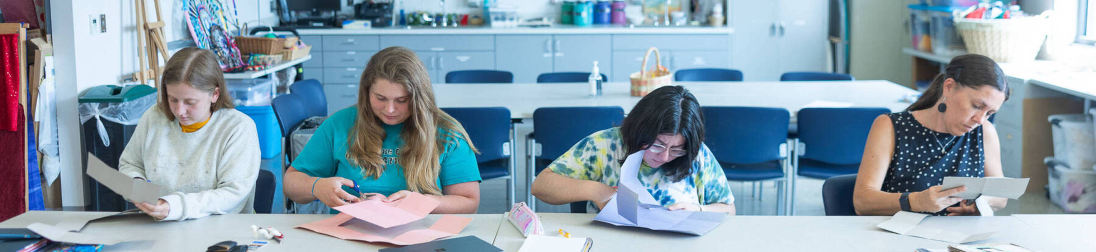 Four art therapy students work in Ursuline's Art Therapy studio space.
