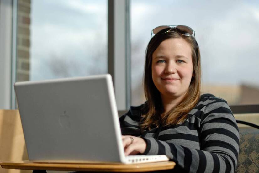 UCAP student with laptop at Ursuline College