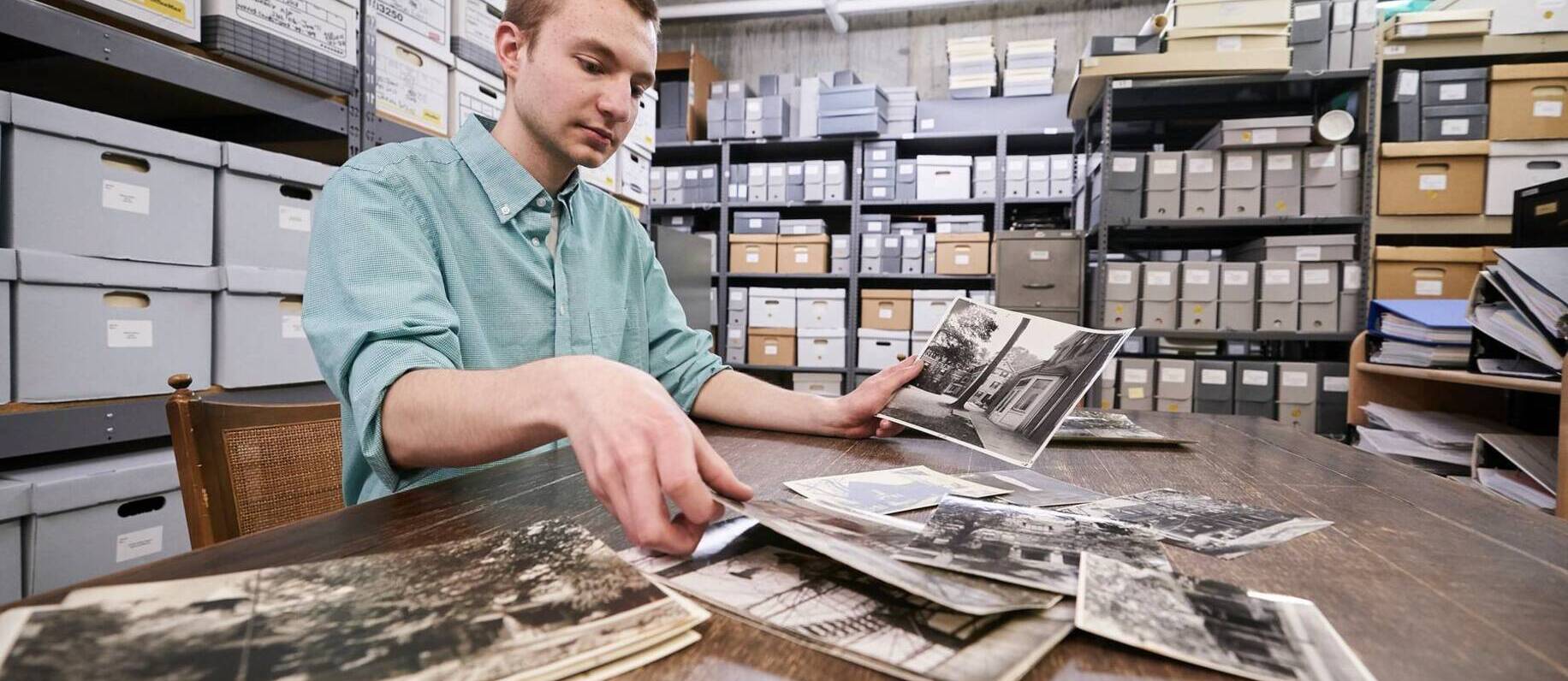 A student looks at archival photos at Ursuline College
